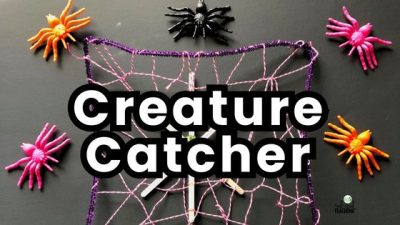 Halloween Activity - Spider Web STEM. Web made of string, pipe cleaners and craft sticks shown with plastic spiders surrounding it.