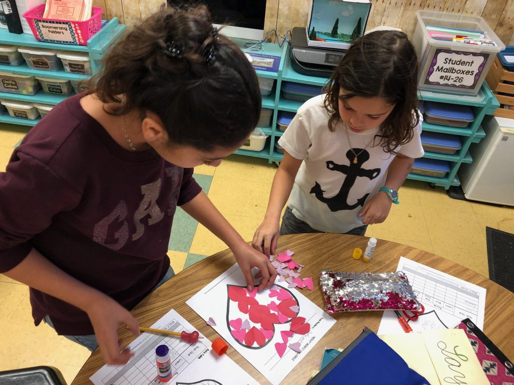 Students designing paper hearts in the Valentine's Day STEM challenge, Heavy Hearts